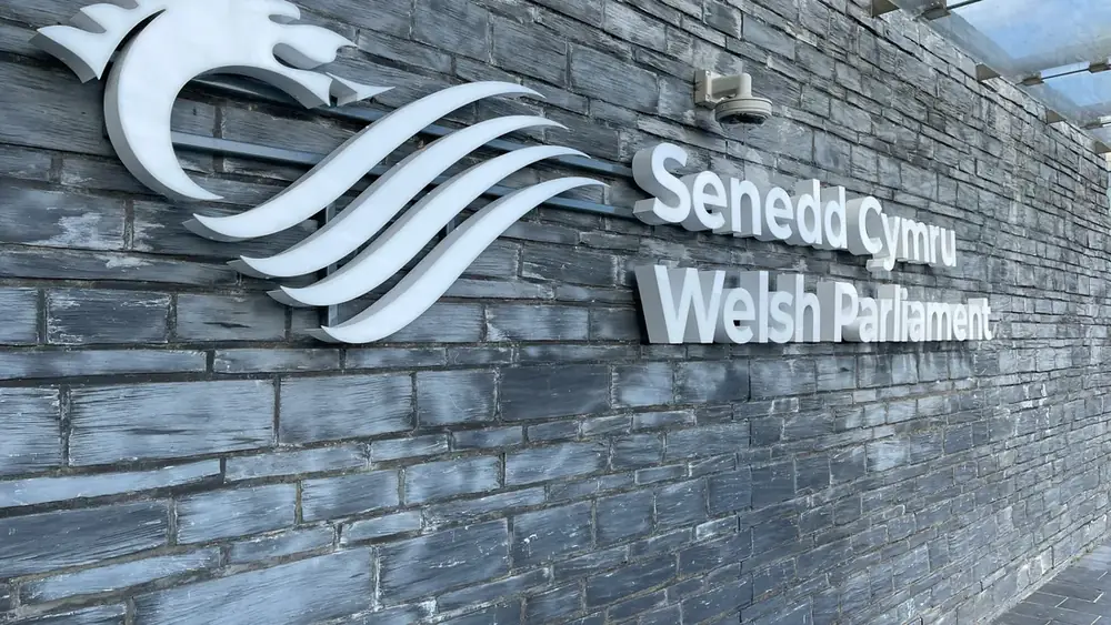 The Senedd Cymru sign on the wall of the Welsh Parliament building in Cardiff Bay